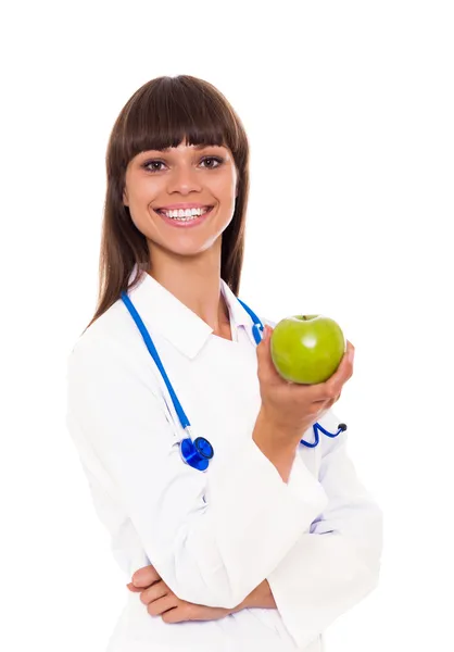 Врач стоматолог Холдинг зеленый свежее яблоко — стоковое фото