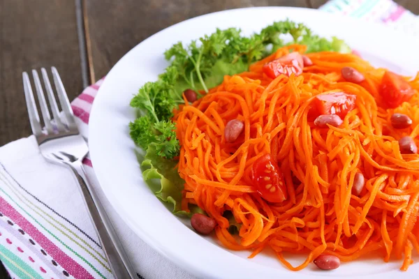 Морковный салат на тарелке на салфетке — стоковое фото