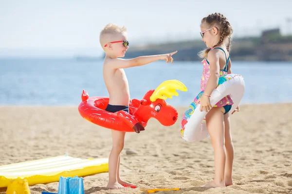 Смешные дети с красочными буев на пляже — стоковое фото
