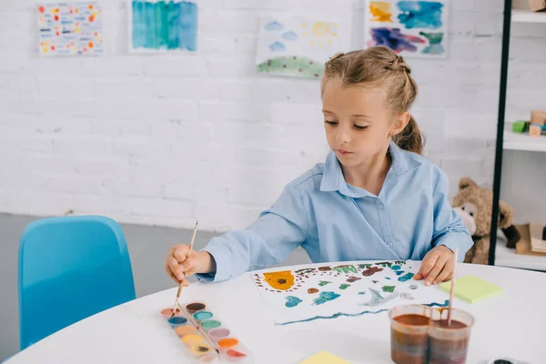 Portrait Adorable Focused Child Drawing Colorful Picture Paints Brush Table — стоковое фото