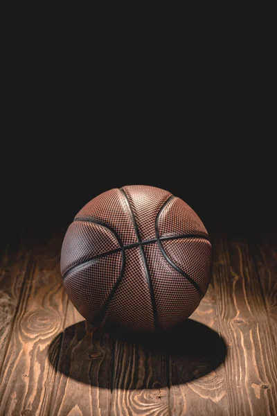 One Brown Basketball Ball Wooden Floor Dark Room — стоковое фото