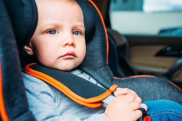 Close Portrait Thoughtful Little Baby Sitting Child Safety Seat Car — стоковое фото