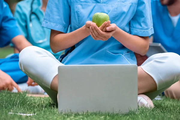 Cropped Image Medical Student Holding Ripe Green Apple Hands Sitting — стоковое фото