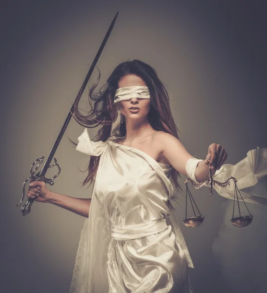 Фемида, богиня справедливости, с весами и мечом носить повязку — стоковое фото