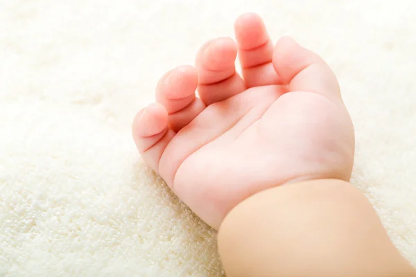 Рука ребенка на полотенце — стоковое фото