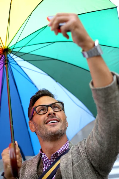 Человек в городе Радужный зонтик Стоковое Изображение