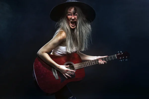 Horror. Dead musician, scary zombie playing on guitar in halloween . — стоковое фото