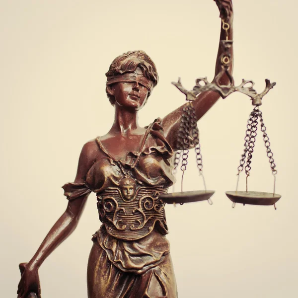 Крупным планом образ Фемиды богиня или леди правосудия проведение масштаба повязку на светлом фоне — стоковое фото