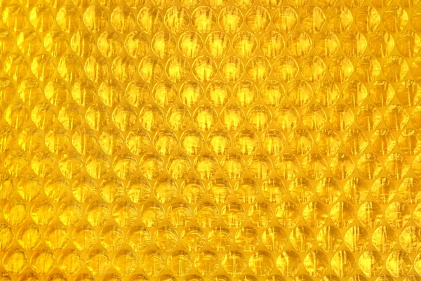 Amber Bubble Wrap Packing Or Air Cushion Film Abstract Backgroun — стоковое фото