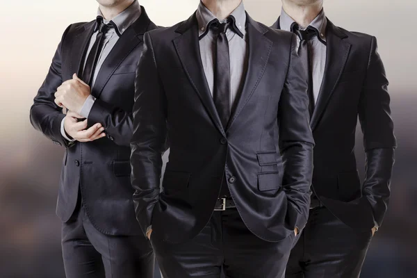 Крупным планом изображение трех деловых мужчин в черном костюме Стоковая Картинка