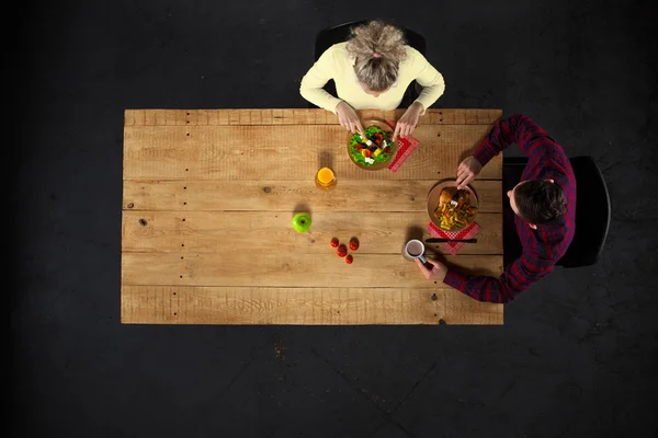 Top view of couple at table with food Лицензионные Стоковые Фото