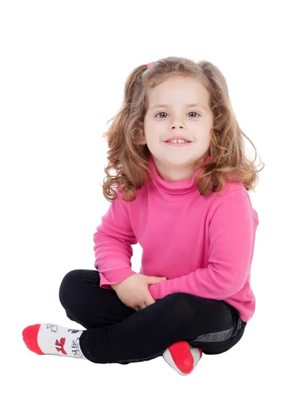Милая маленькая девочка, сидя на полу — стоковое фото