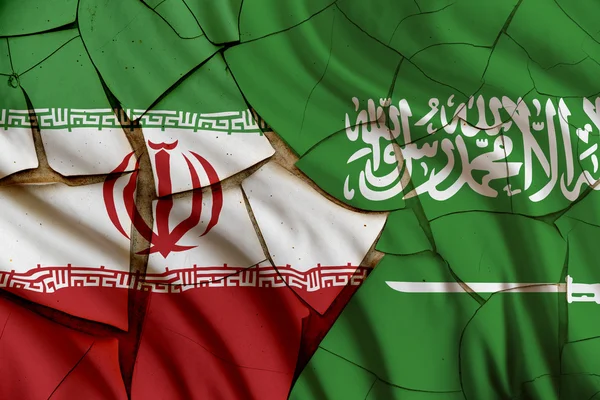 Flags of Iran and Saudi Arabia on a cracked paint wall. Лицензионные Стоковые Фото
