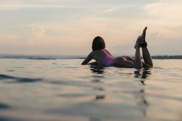 Lying on surfboard — стоковое фото