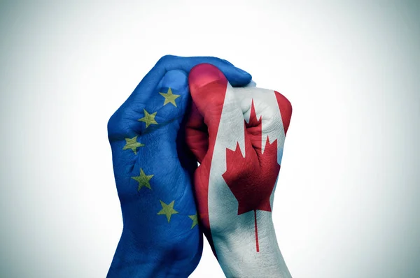 Руки, узорные с европейскими и флаги Канады положить toget Стоковая Картинка