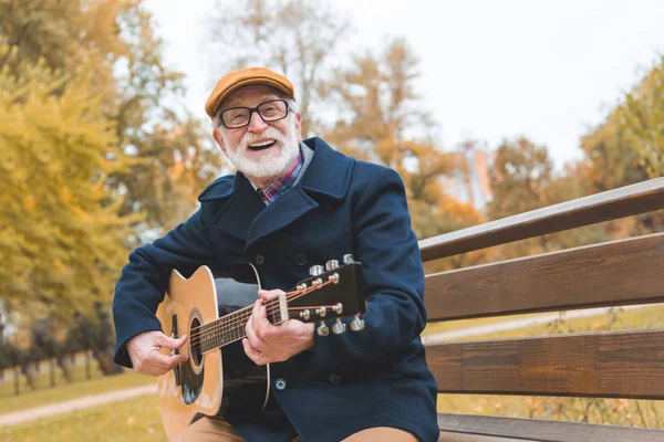Старший мужчина, играть на гитаре — стоковое фото