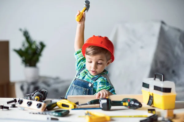 Adorable Little Kid Red Hard Hat Playing Wooden Plank Toy — стоковое фото