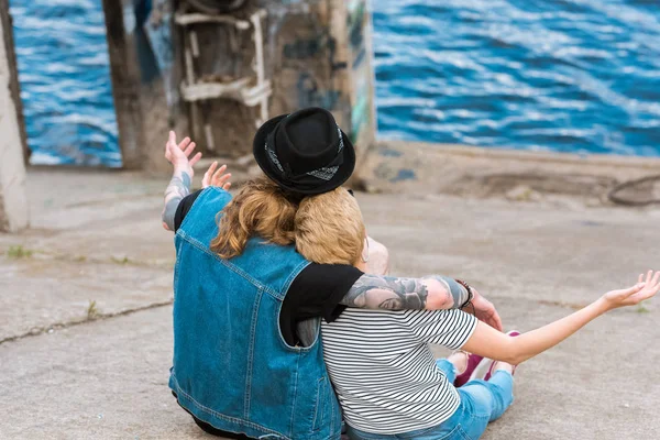 Back View Couple Sitting Looking River Open Arms — стоковое фото