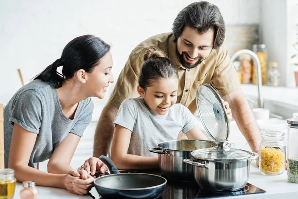 Smiling Young Family Cooking Together Kitchen — стоковое фото