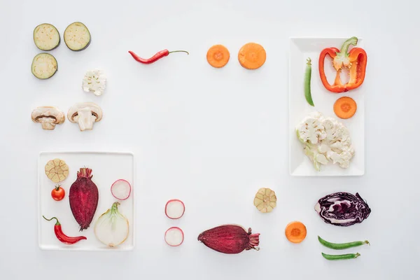 Top View Square White Plates Fresh Sliced Vegetables Isolated White — стоковое фото