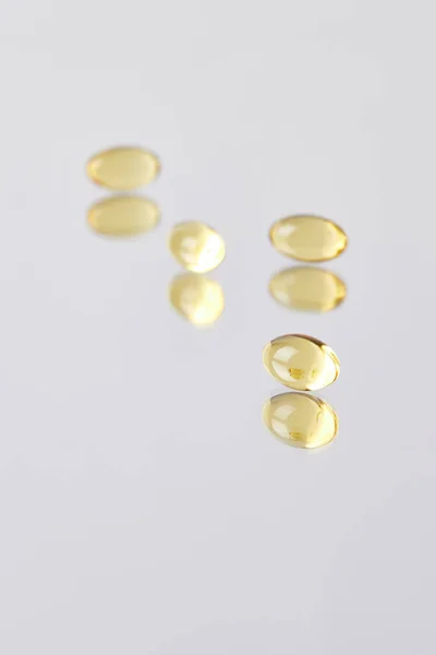 Close Shot Omega Fish Hat Supplement Capsules Reflective Surface — стоковое фото