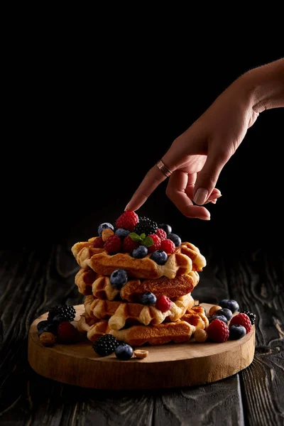 Cropped Shot Woman Touching Stack Belgian Waffles Berries Black Wooden — стоковое фото