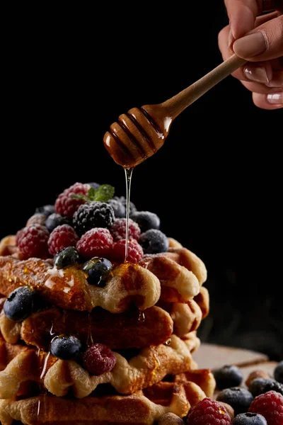 Cropped Shot Woman Pouring Honey Stack Belgian Waffles Black — стоковое фото