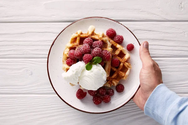 Cropped Shot Man Holding Plate Belgian Waffles Raspberries Ice Cream — стоковое фото