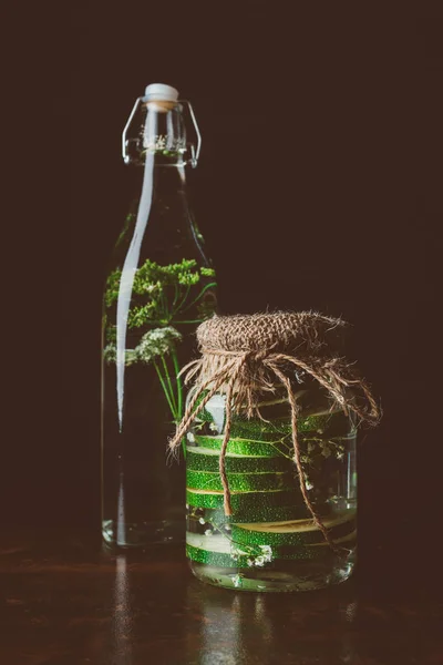 Glass Bottle Water Dill Glass Jar Zucchini Wooden Table Black — стоковое фото