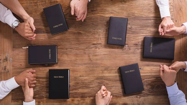 High Angle View People Praying Hands Holy Bible — стоковое фото