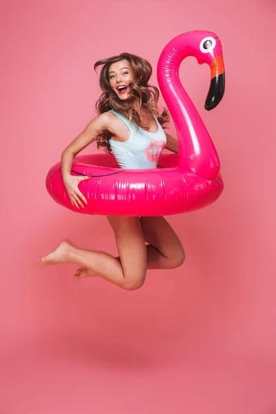 Full Length Portrait Happy Young Woman Dressed Swimsuit Jumping Inflatable — стоковое фото