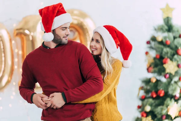 Happy Girlfriend Hugging Her Boyfriend Home Christmas Tree — стоковое фото