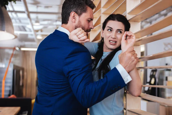 Aroused man seducing a woman at work Стоковая Картинка