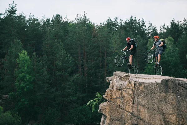 Side View Young Trial Bikers Backpacks Standing Back Wheels Rocky Лицензионные Стоковые Фото