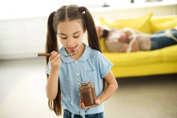 Father Lying Tied Sofa Daughter Eating Chocolate Home Стоковое Фото