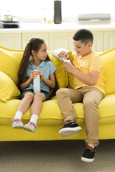 Sister Brother Eating Cream Sofa Home — стоковое фото