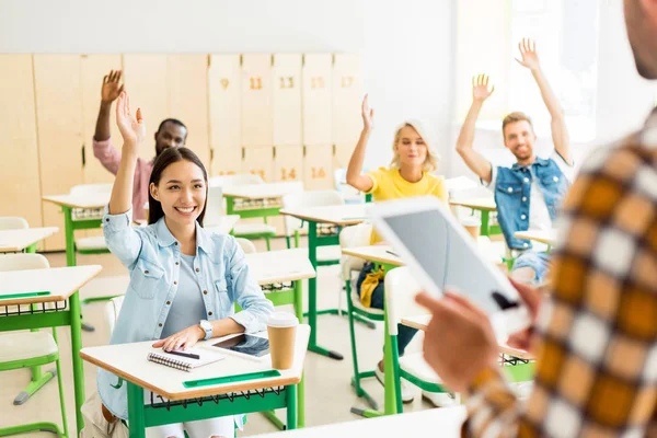 Young Students Raising Hands Answer Teachers Question While Standing Tablet Лицензионные Стоковые Фото