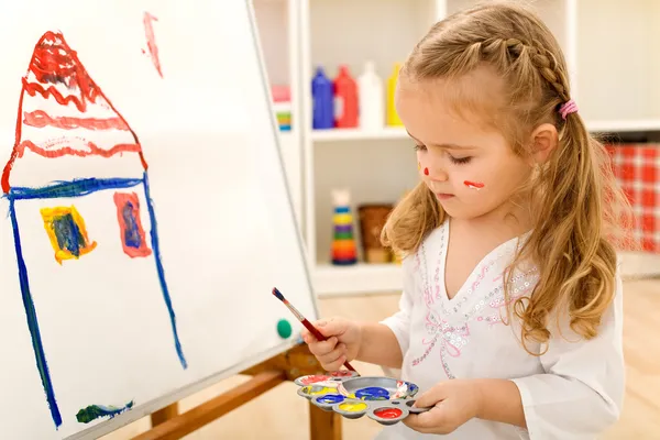 Маленькая девочка художника, живопись на бумаге большого формата холсте — стоковое фото